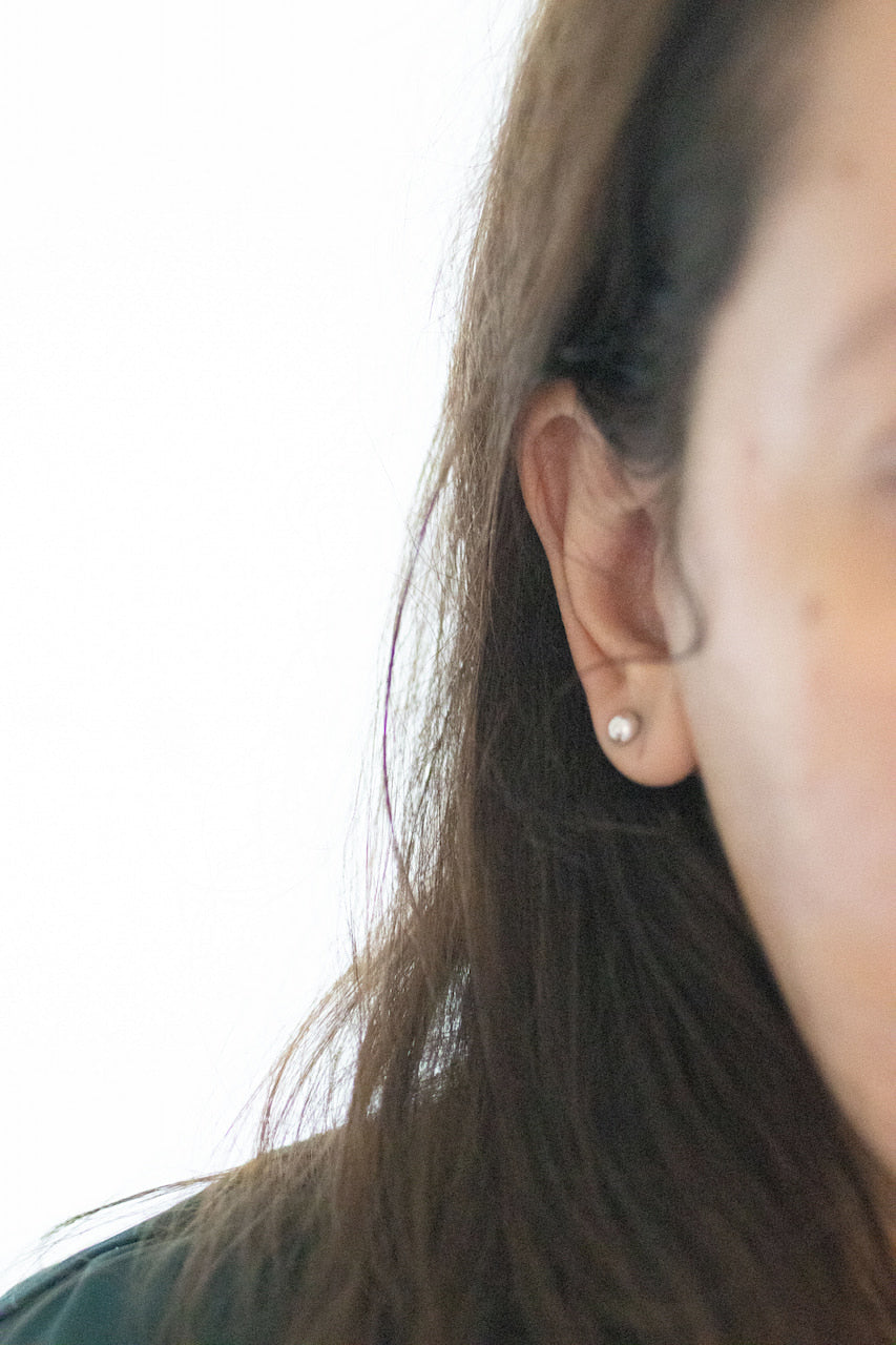 A silver moon and its porcelain orbit - two earrings in one