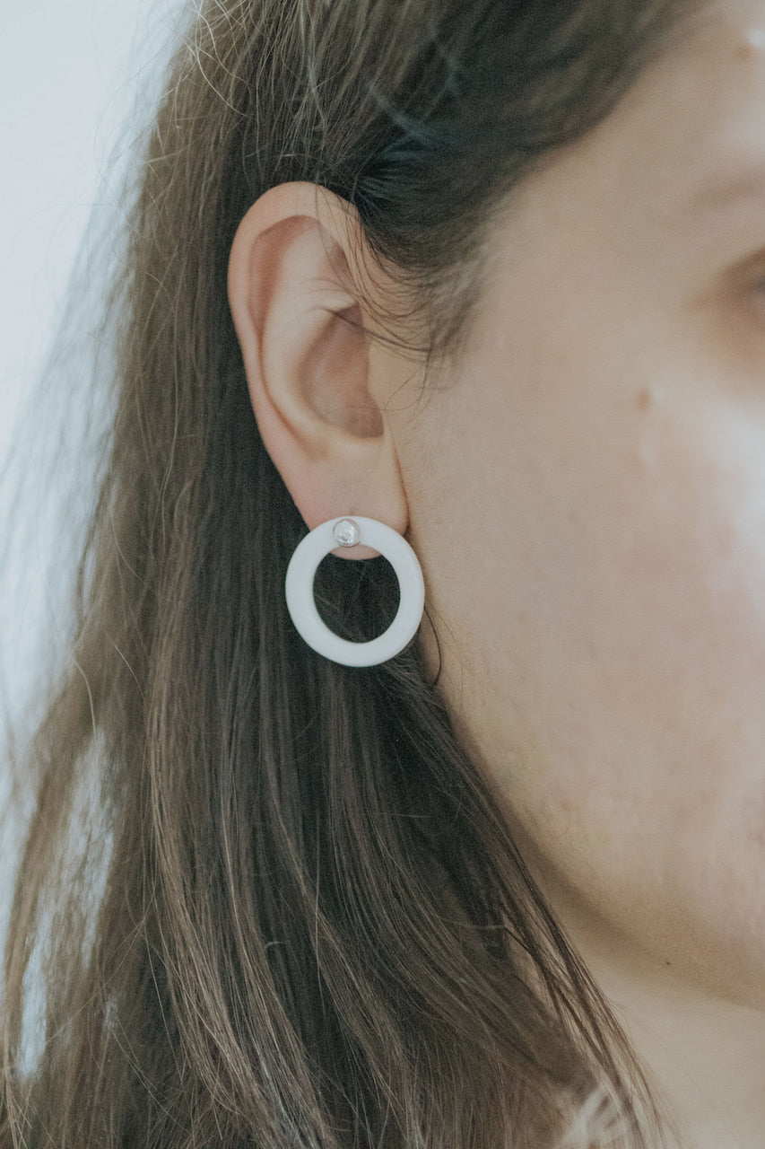 A silver moon and its porcelain orbit - two earrings in one