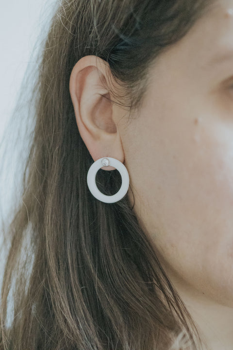 A silver moon and its porcelain orbit - two earrings in one