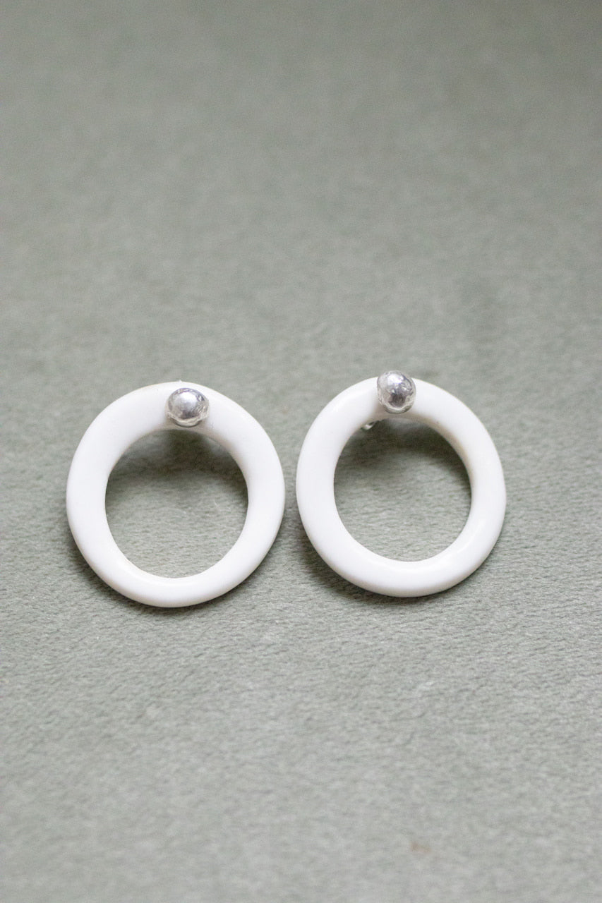 A silver moon and its porcelain orbit - two earrings in one