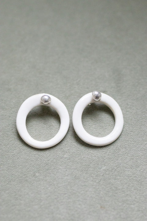 A silver moon and its porcelain orbit - two earrings in one
