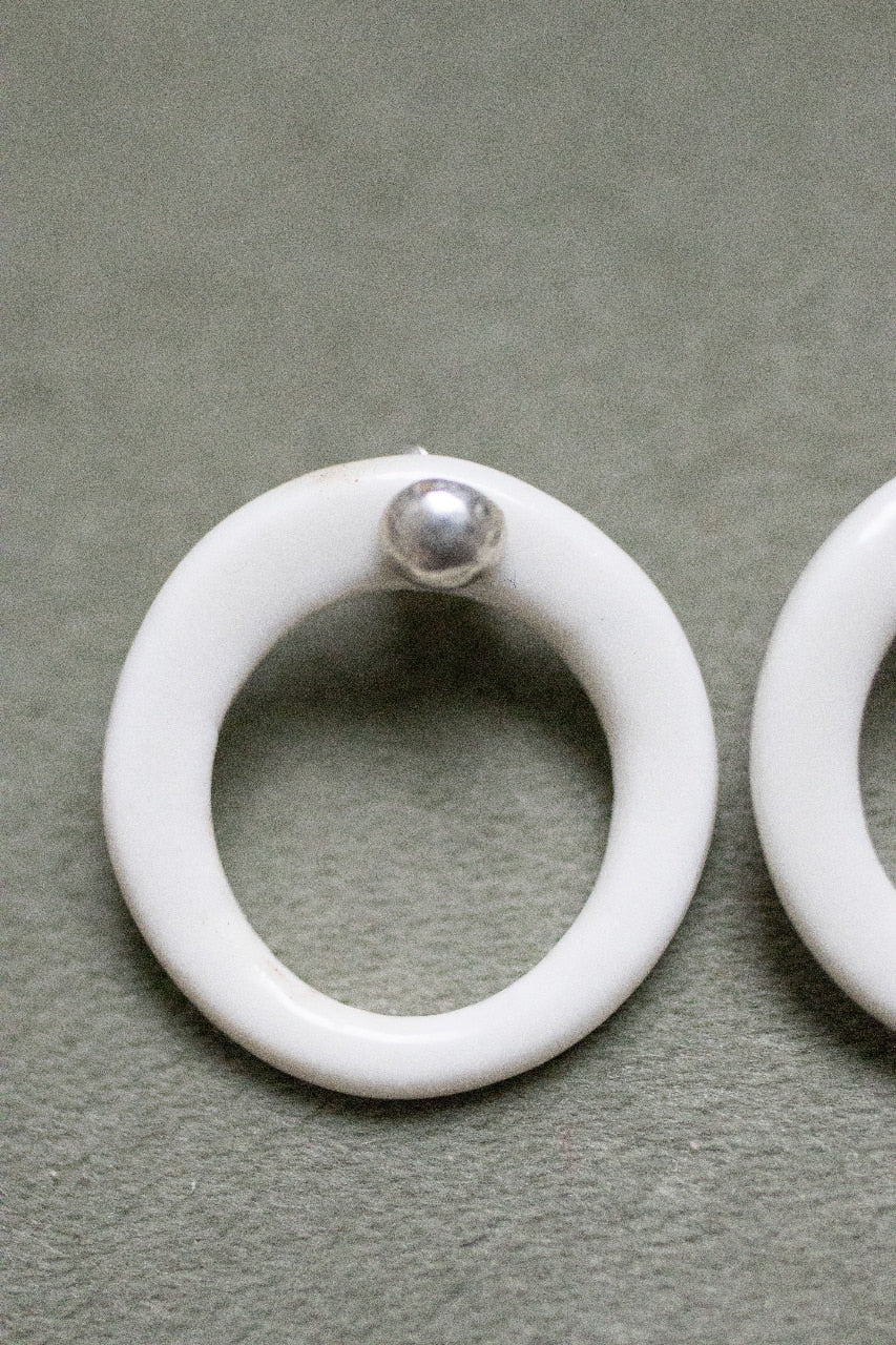 A silver moon and its porcelain orbit - two earrings in one